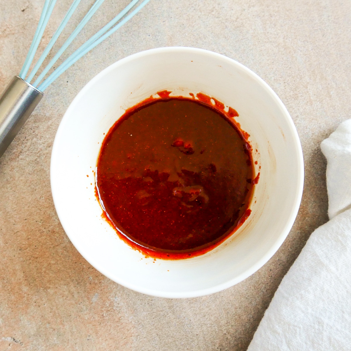 gochujang sauce mixed together in a small bowl with a whisk. 