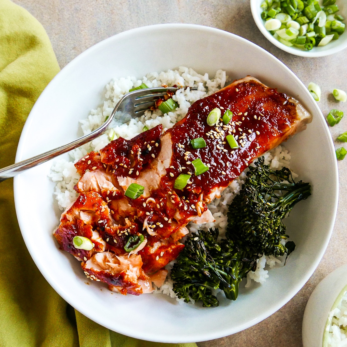 Korean salmon in a bowl with rice cut into pieces.