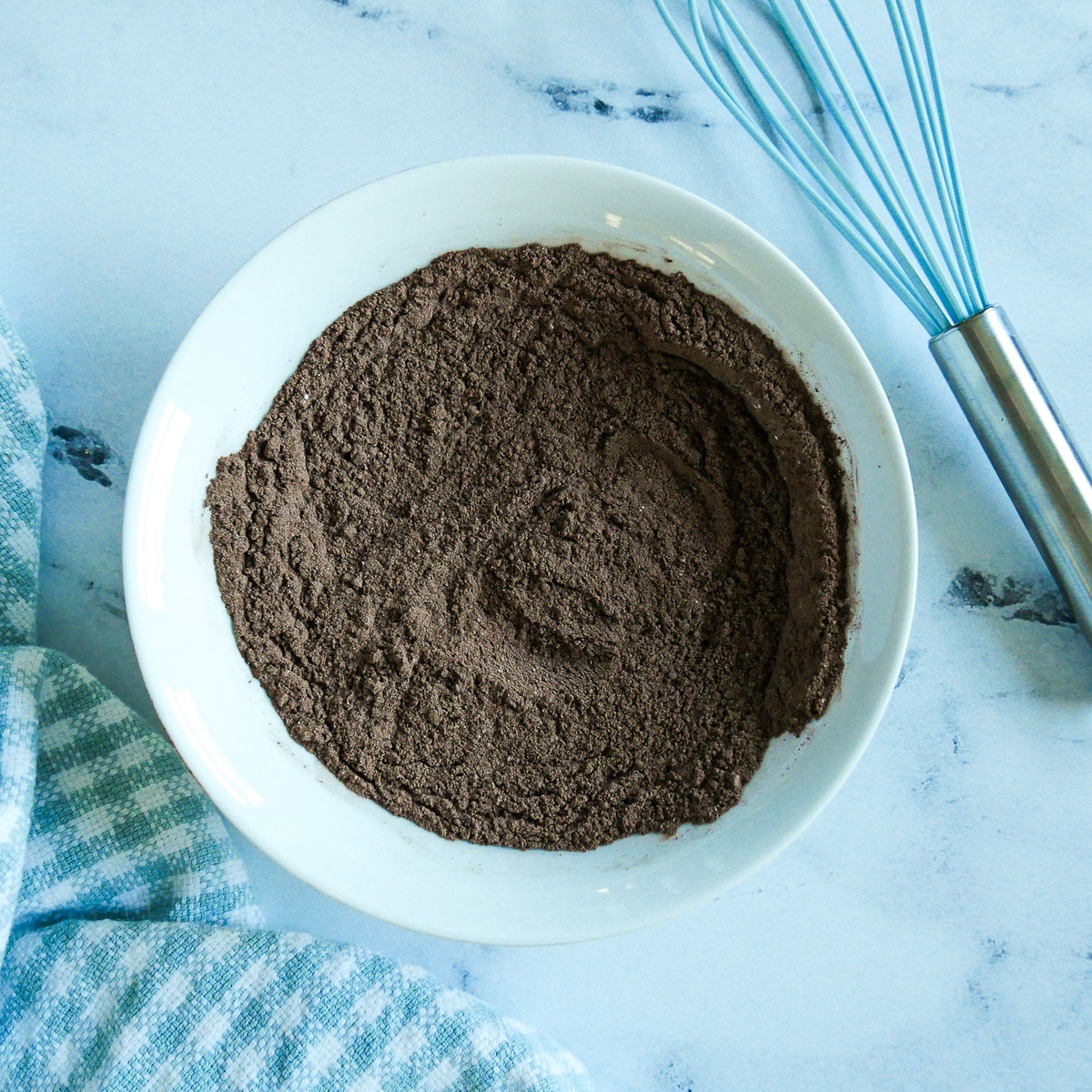Dry ingredients whisked together in a white bowl.