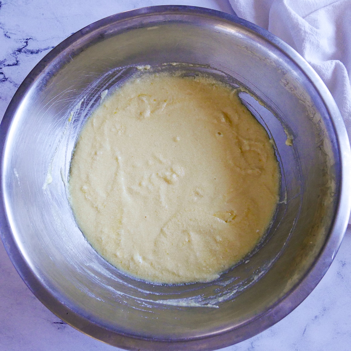 Eggs, ricotta, lemon, and vanilla mixed into cake batter.
