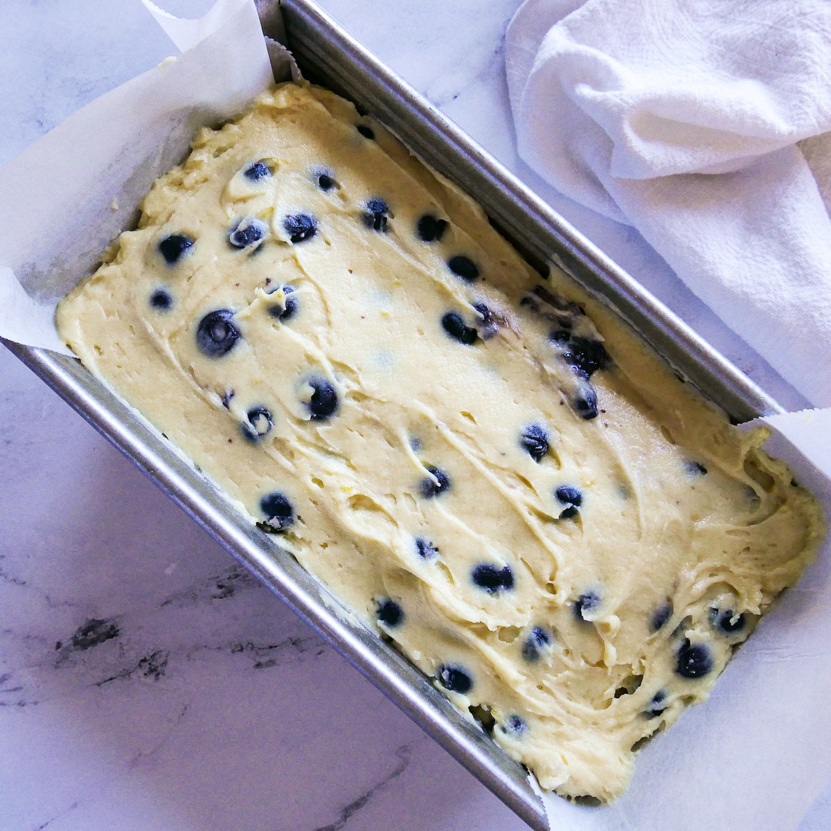 pound cake batter poured into a prepared loaf pan.