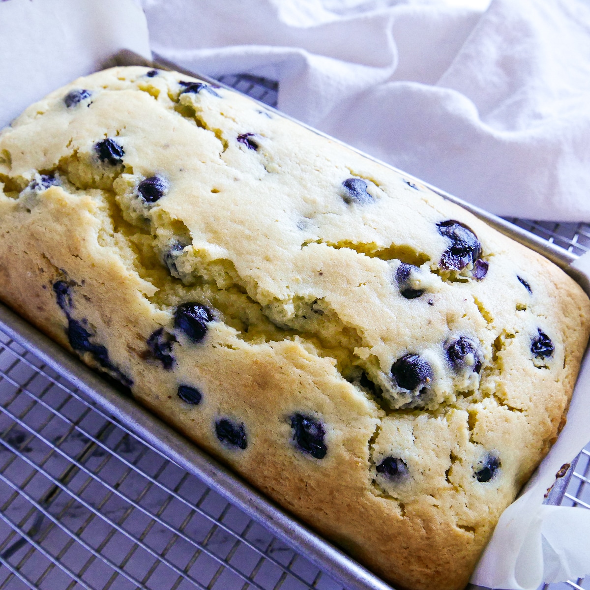 baked pound cake cooling on a wire rack.