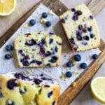 blueberry lemon pound cake sliced onto parchment paper.