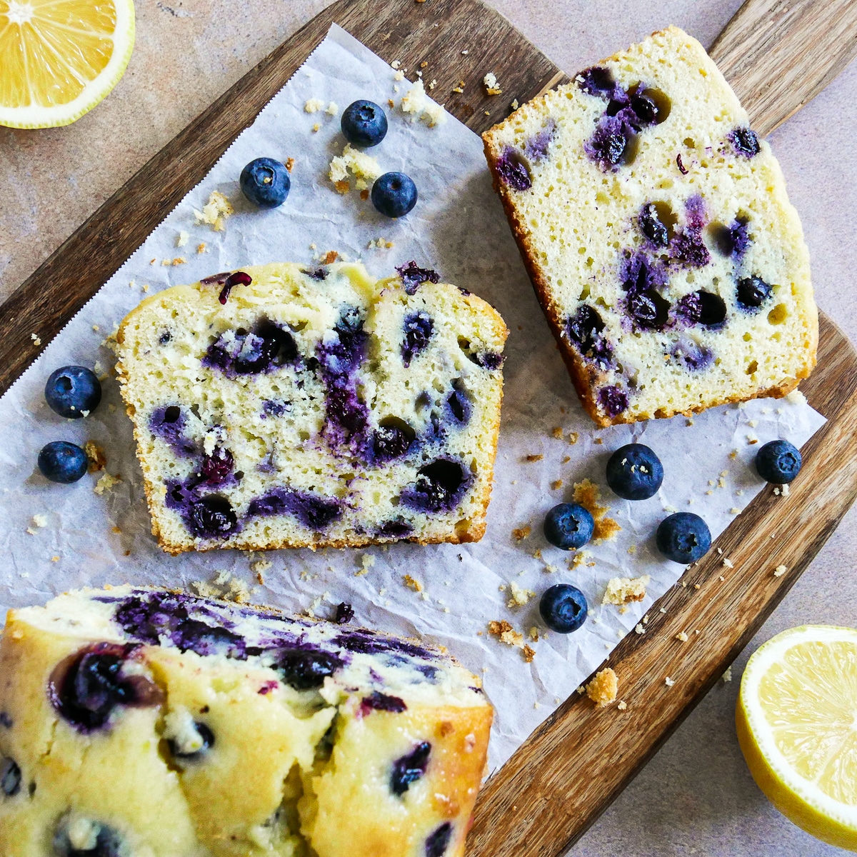 blueberry lemon pound cake sliced onto parchment paper.