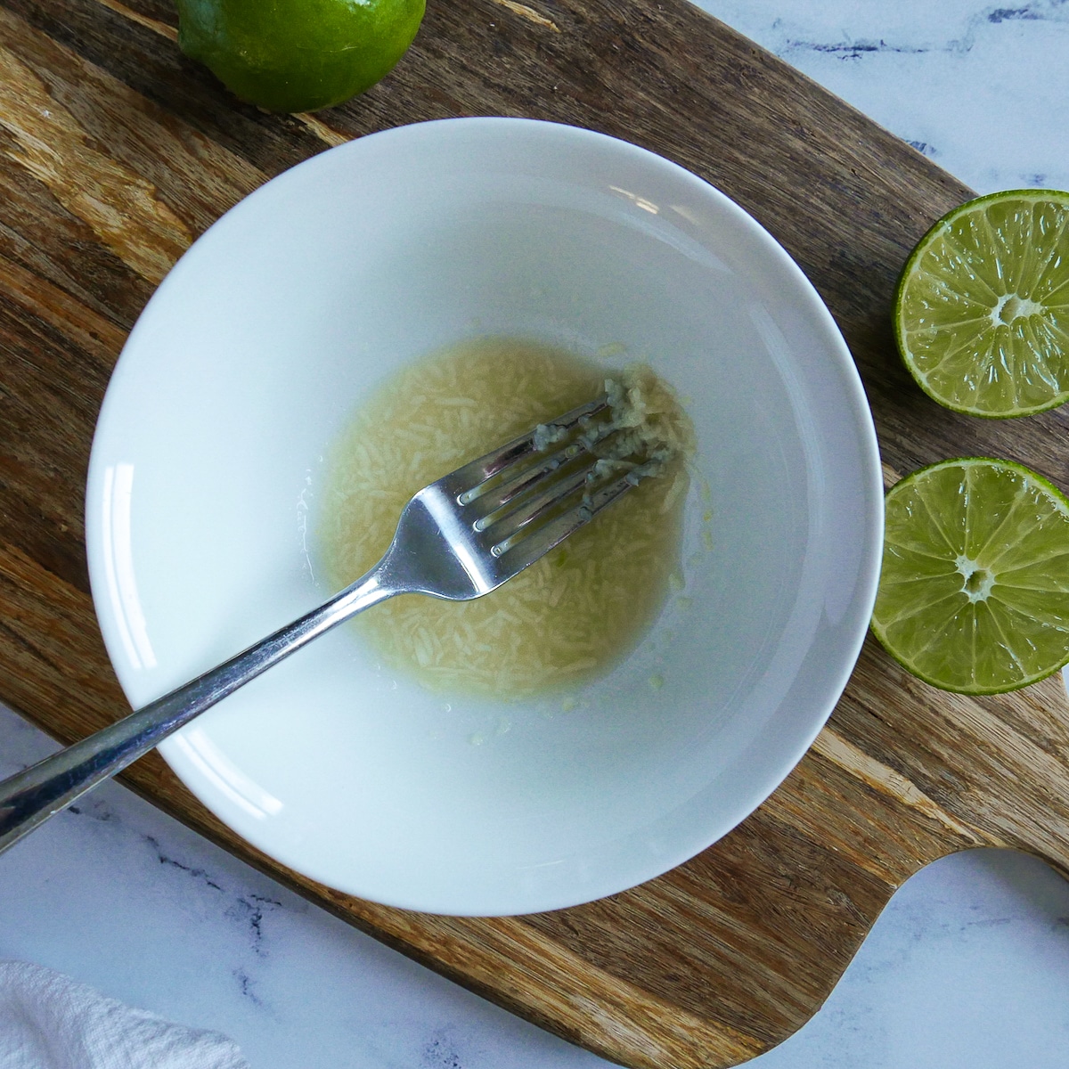 bowl with lime juice, garlic, and salt.