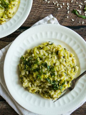 plate of zucchini risotto resting on a white napkin.