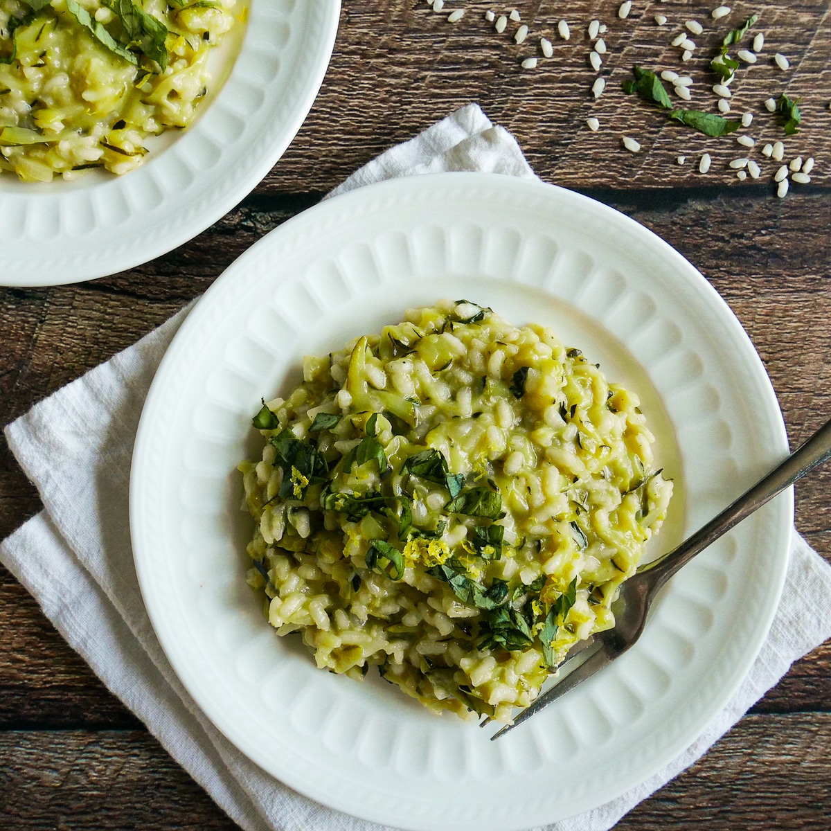 zucchini-risotto.jpg plate of zucchini risotto resting on a white napkin.