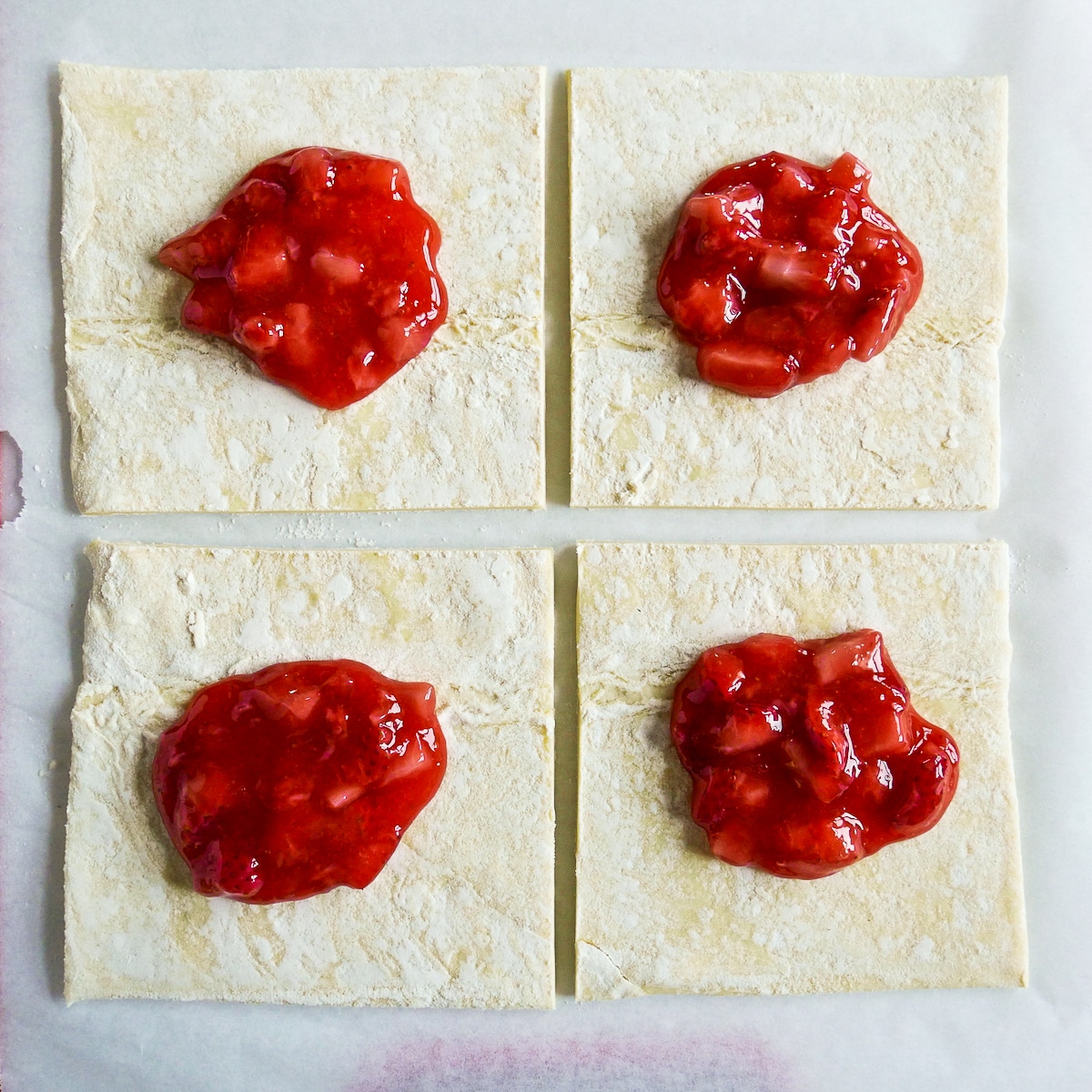 Strawberry filling placed into center of pastry squares.