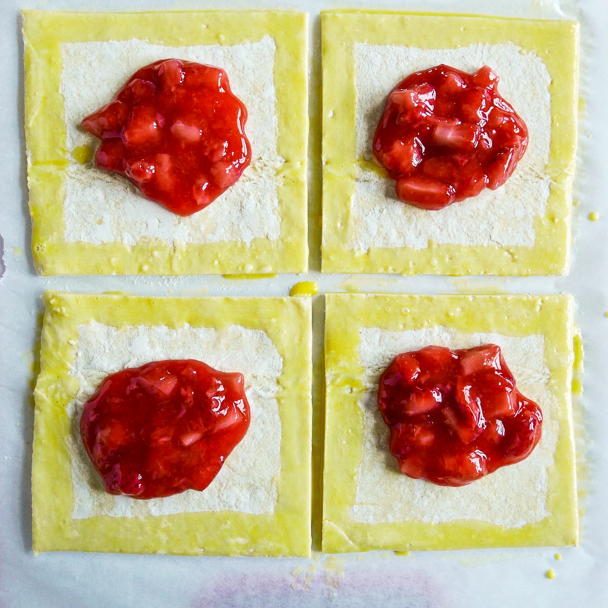 egg-wash-on-pastry.jpg Egg wash brushed on edges of pastry squares.