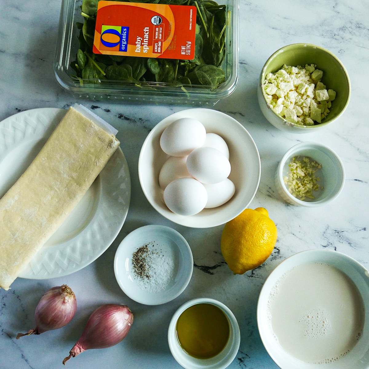 Quiche ingredients arranged on a table.