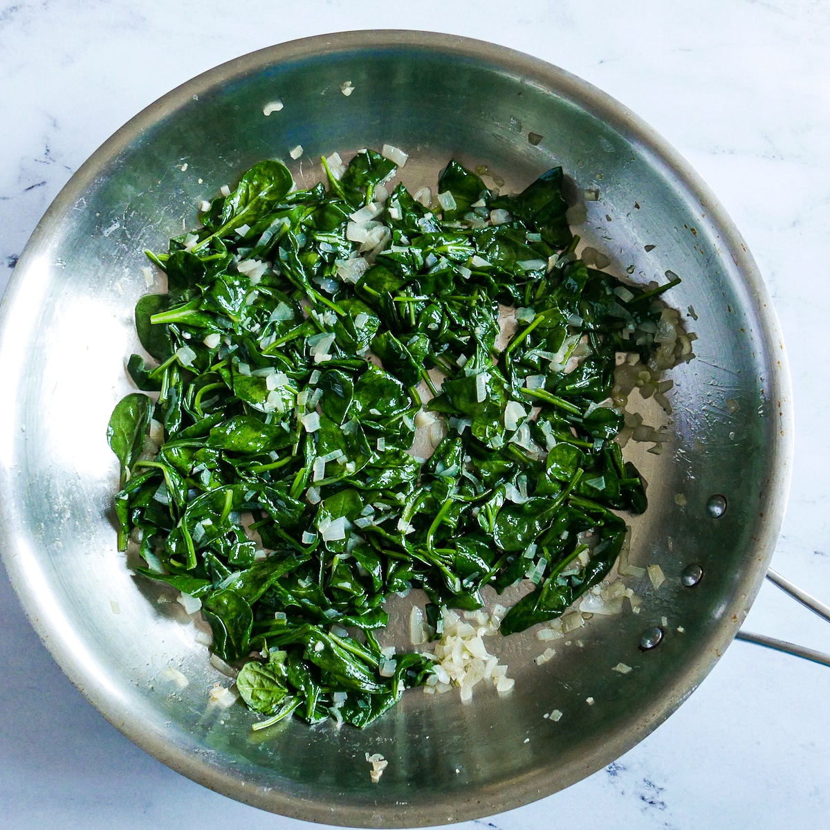 Spinach wilted in shallot mixture.