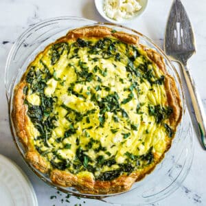 Puff pastry quiche arranged with a pie server.