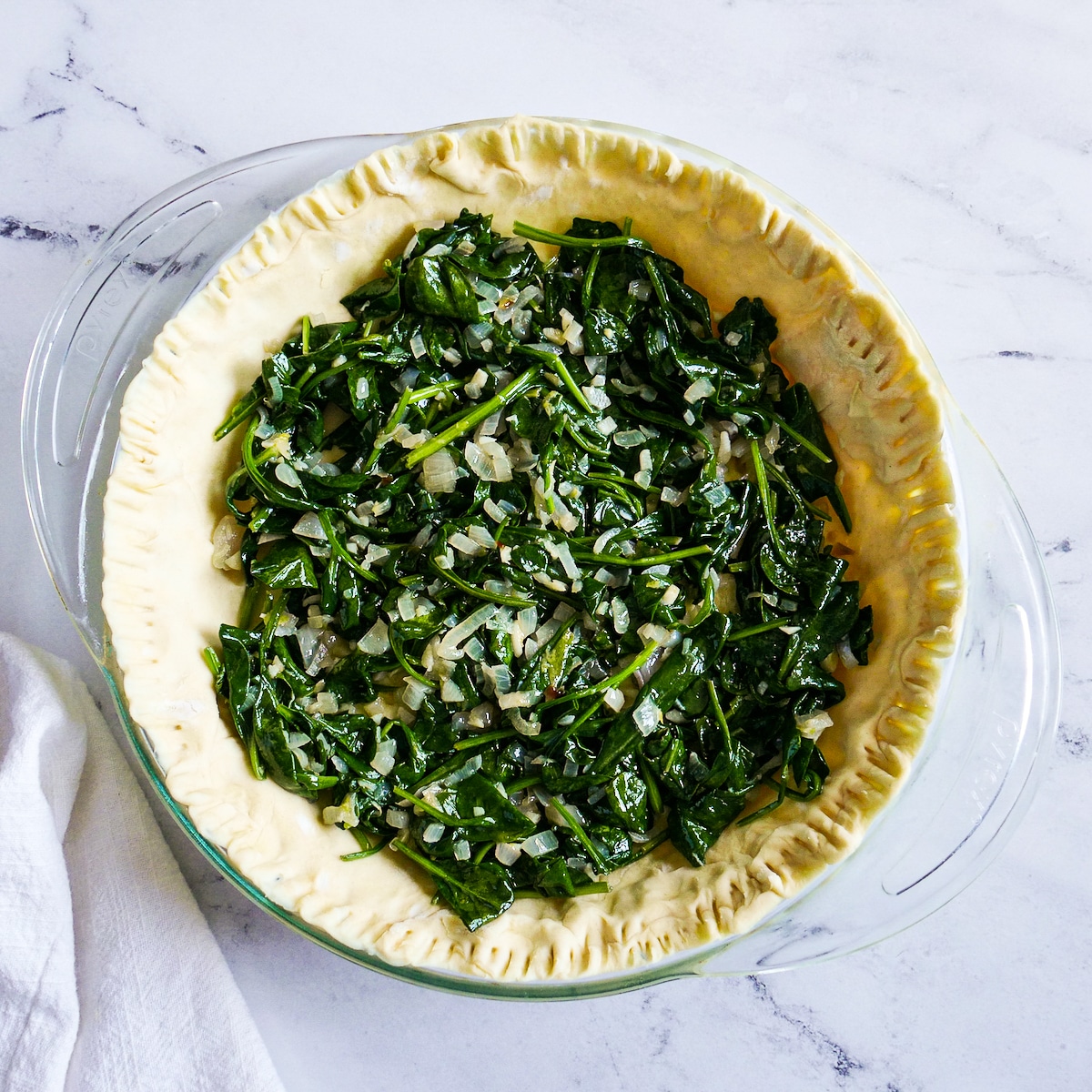 Cooked spinach mixture in prepared pastry shell.