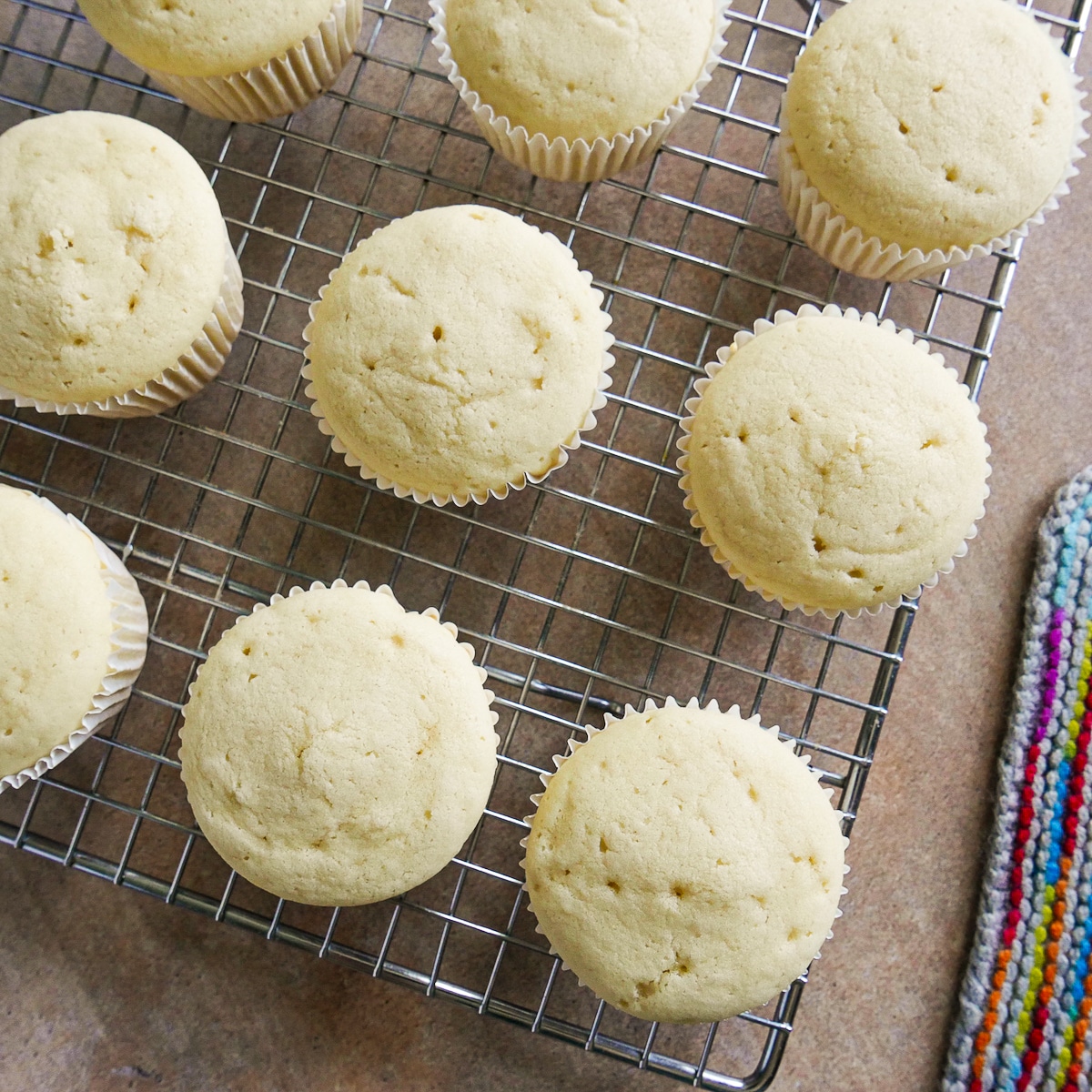 Cupcakes cooling on a wire rack.