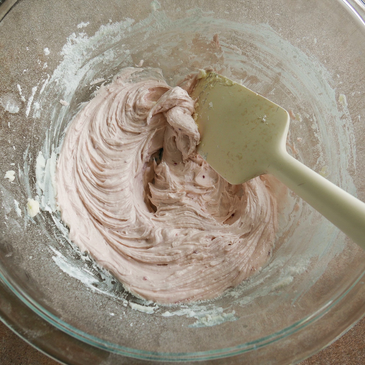 Raspberry frosting combined in a mixing bowl.