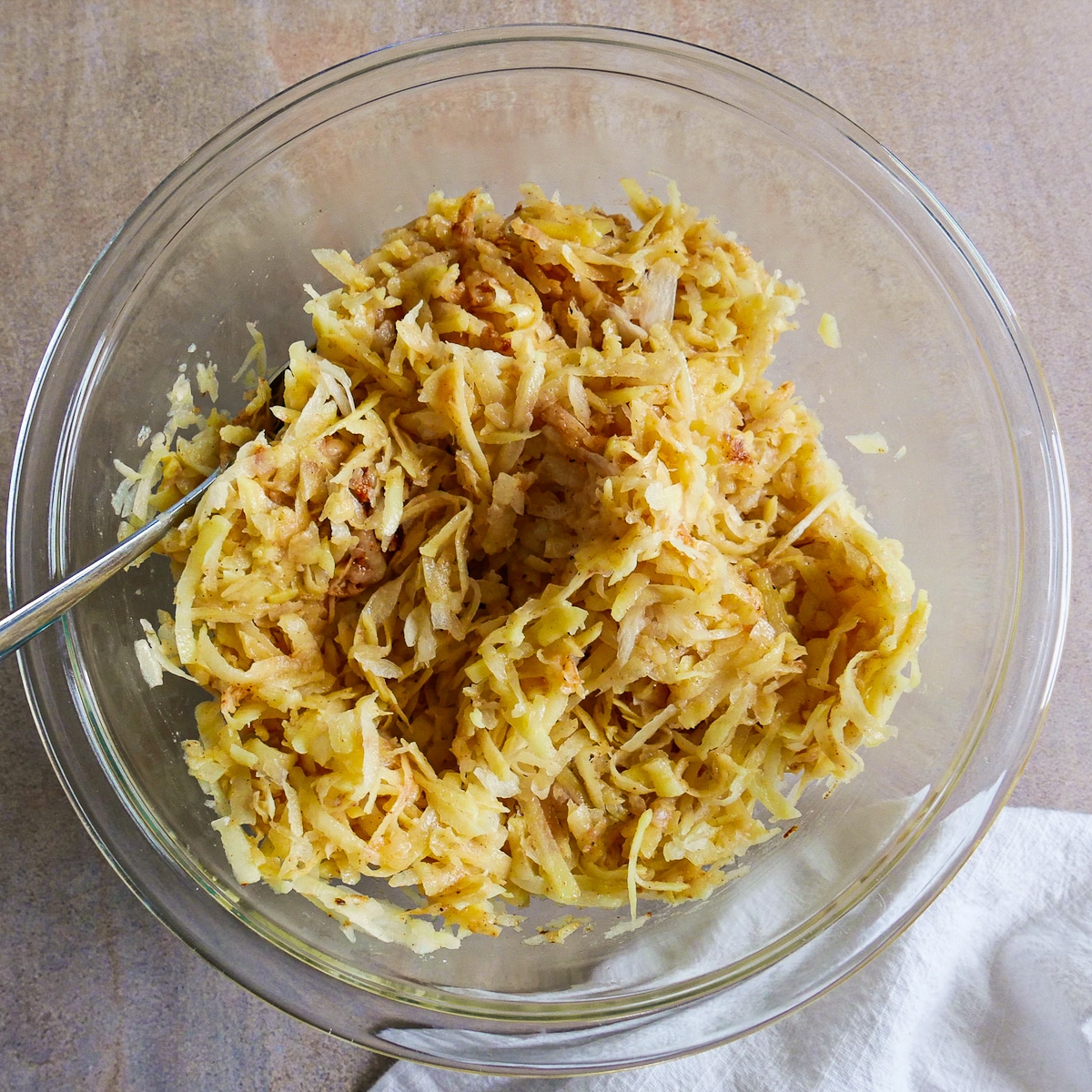 Fritter mixture combined with ingredients in a mixing bowl.