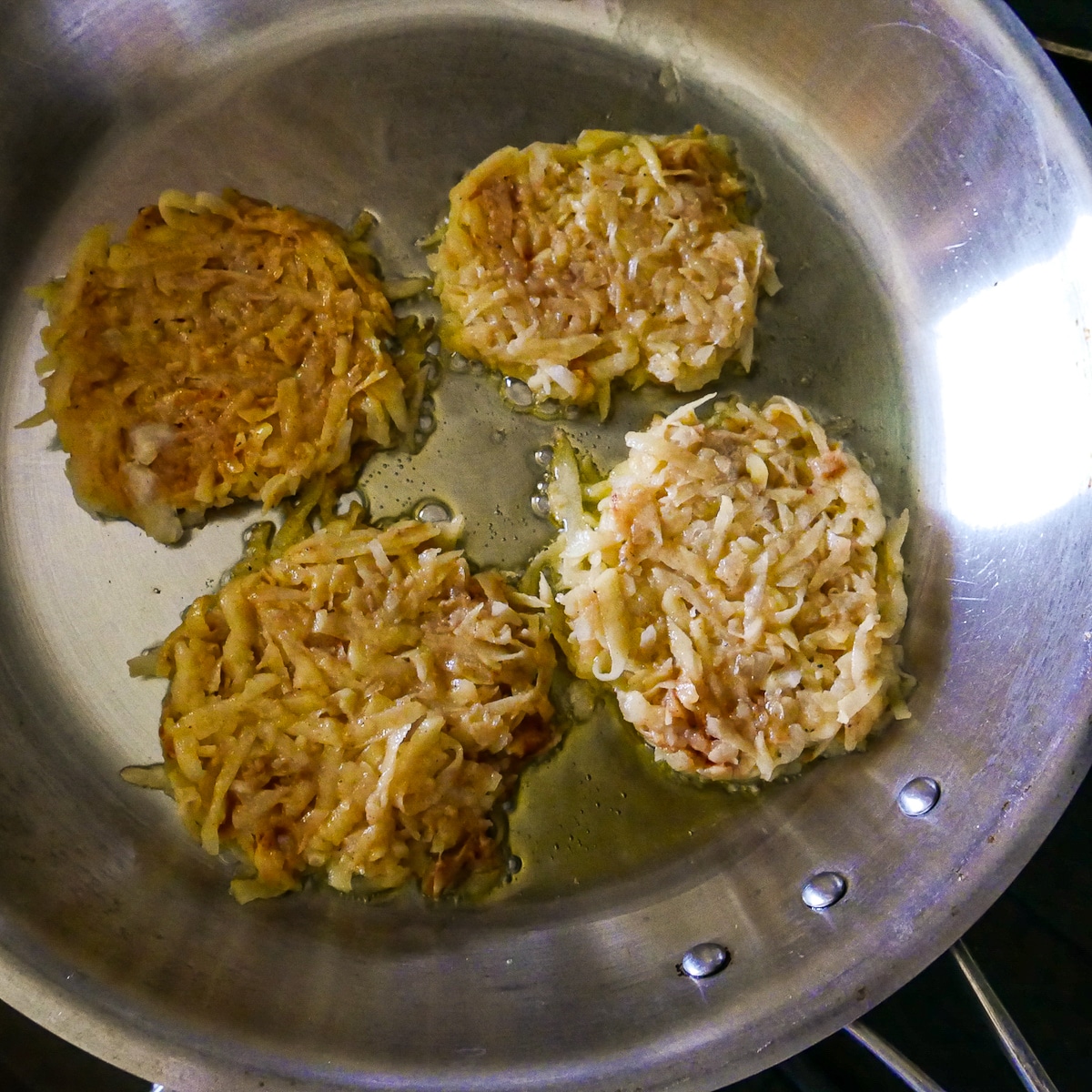 Fritter batter placed into a hot skillet.