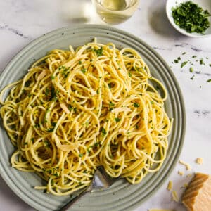 Plate of spaghetti pasta with a fork resting on the side.