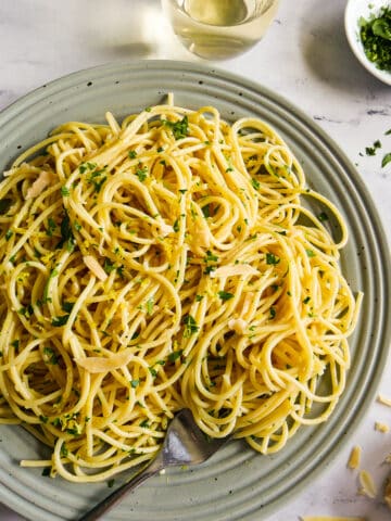 Plate of spaghetti pasta with a fork resting on the side.