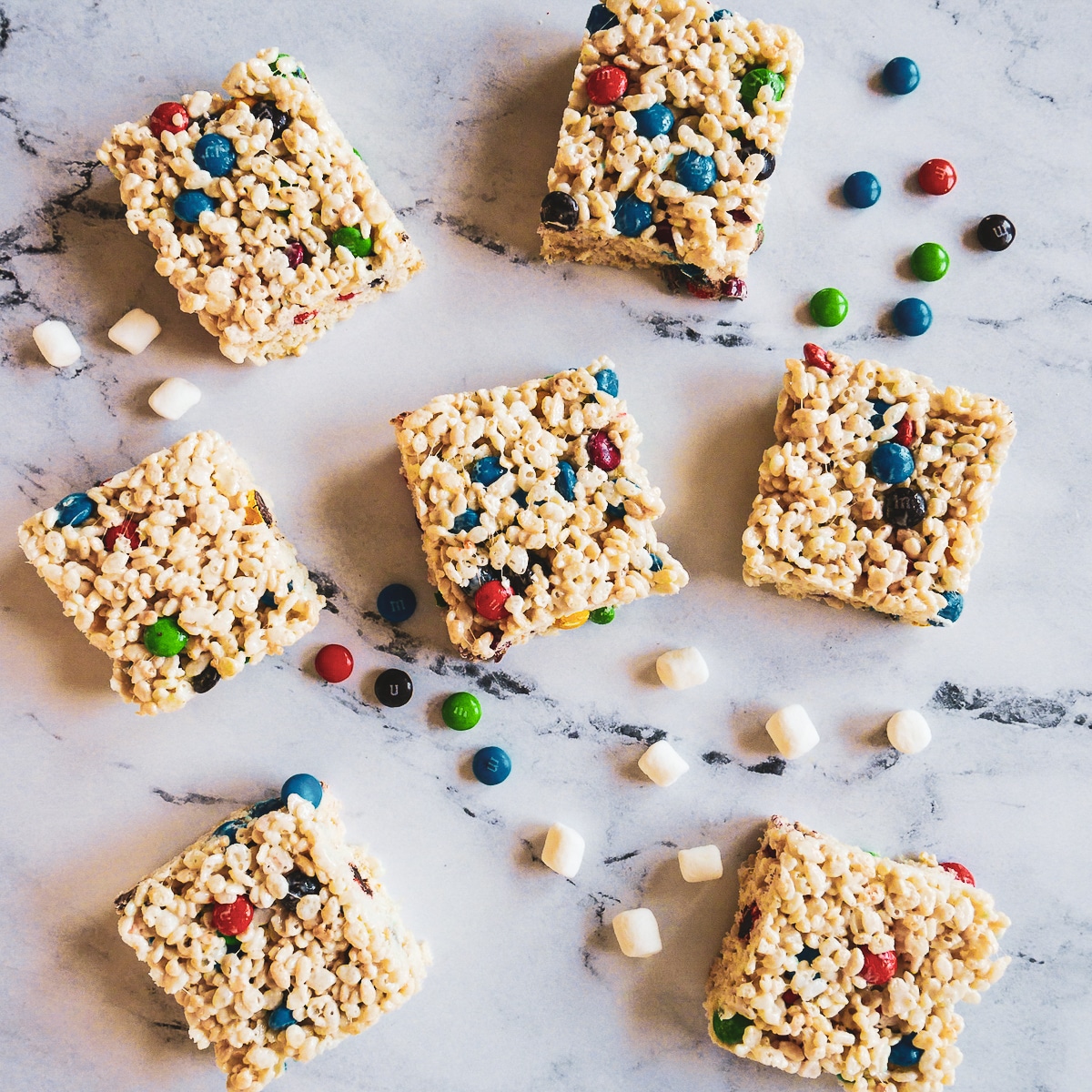 rice-krispie-treats.jpg Rice krispie treats with m&m's arranged on a table.