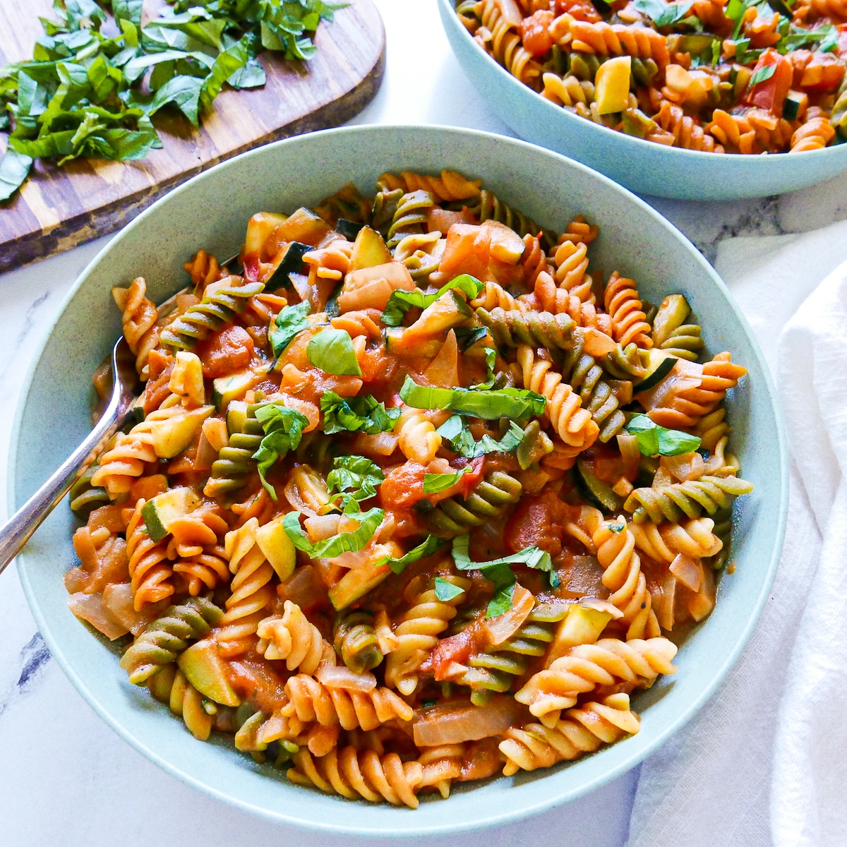 one-pot-veggie-pasta.jpg one pot vegetarian pasta in a large bowl with spoon.