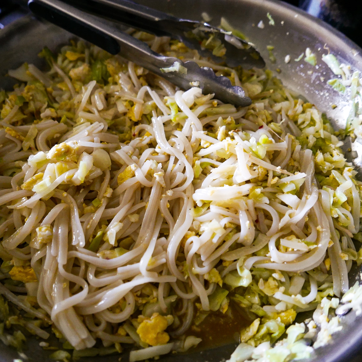 noodles-and-cabbage.jpg Rinsed noodles and sauce being added to cooked cabbage mixture in a large skillet.