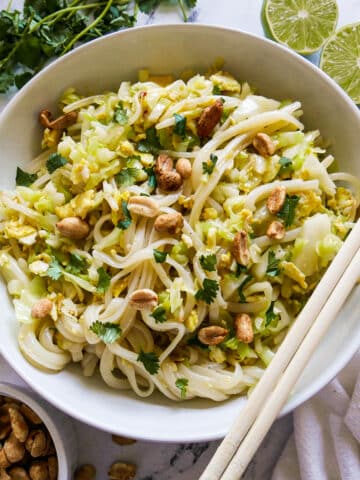 bowl of healthy pad thai with chopsticks resting on bowl.