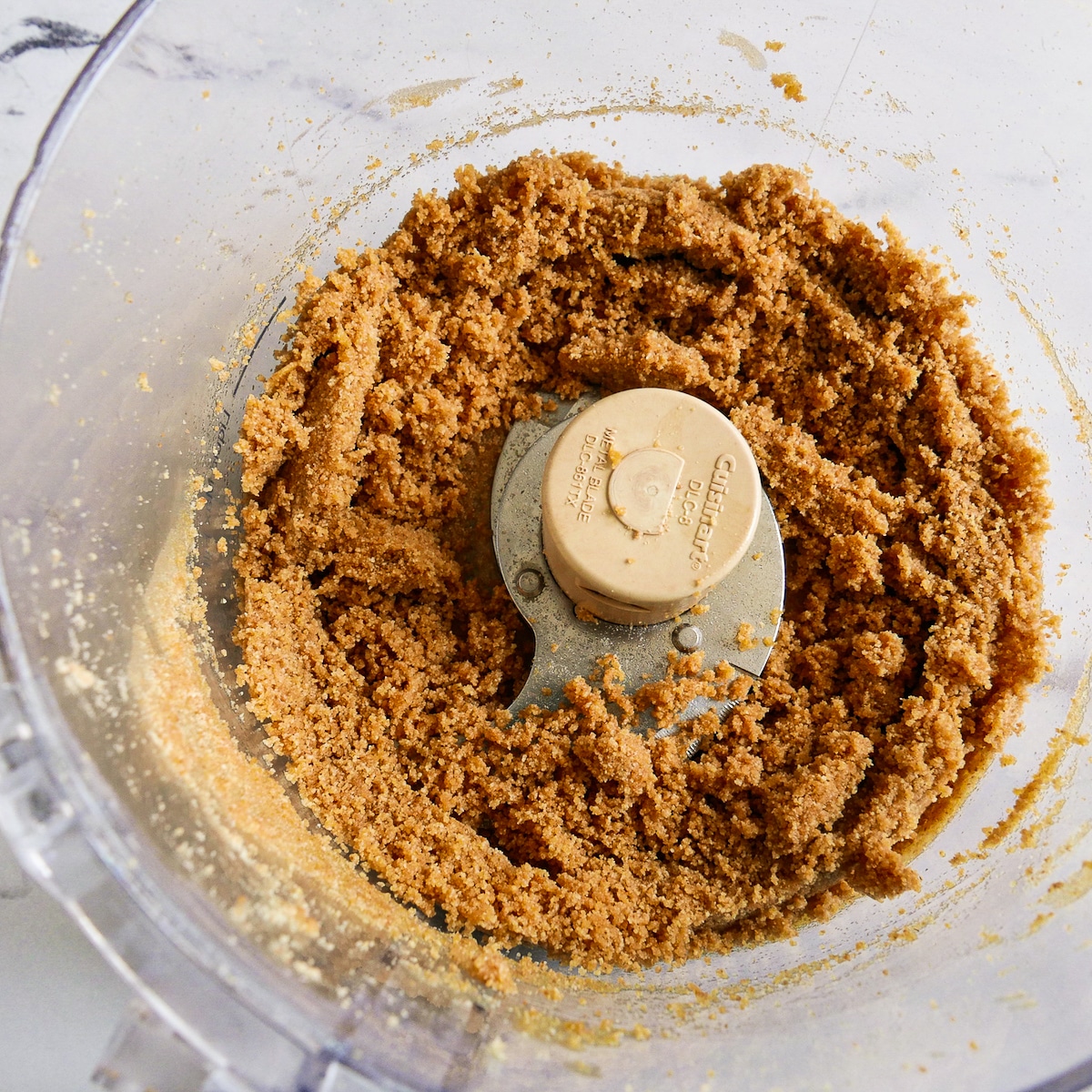 Melted butter and graham crackers mixed in a food processor.