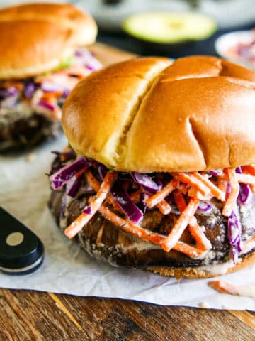 portobello mushroom sandwiches arranged on a cutting board.