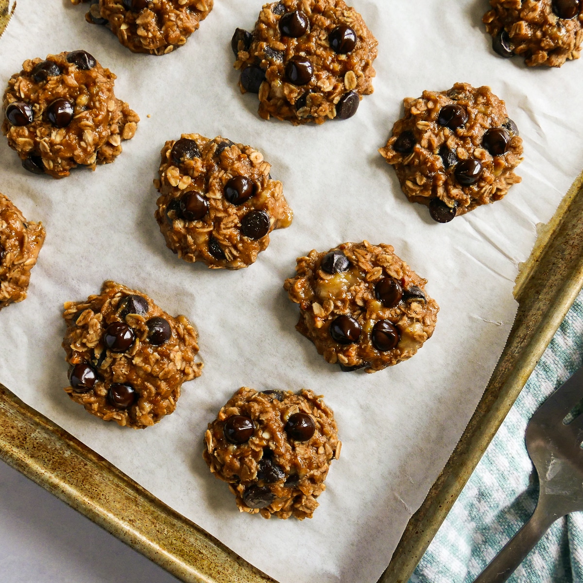 Baked cookies on a baking sheet with parchment.