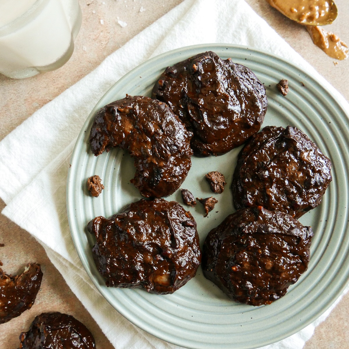 4 ingredient cookies arranged on a blue plate with crumbs.