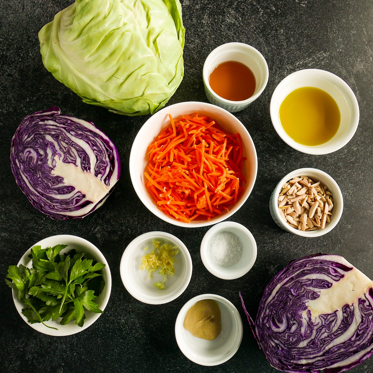 Slaw ingredients arranged on a black table.