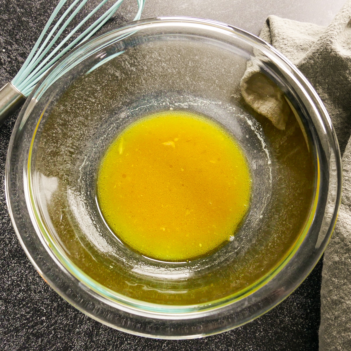 Mustard vinaigrette whisked together in a bowl.