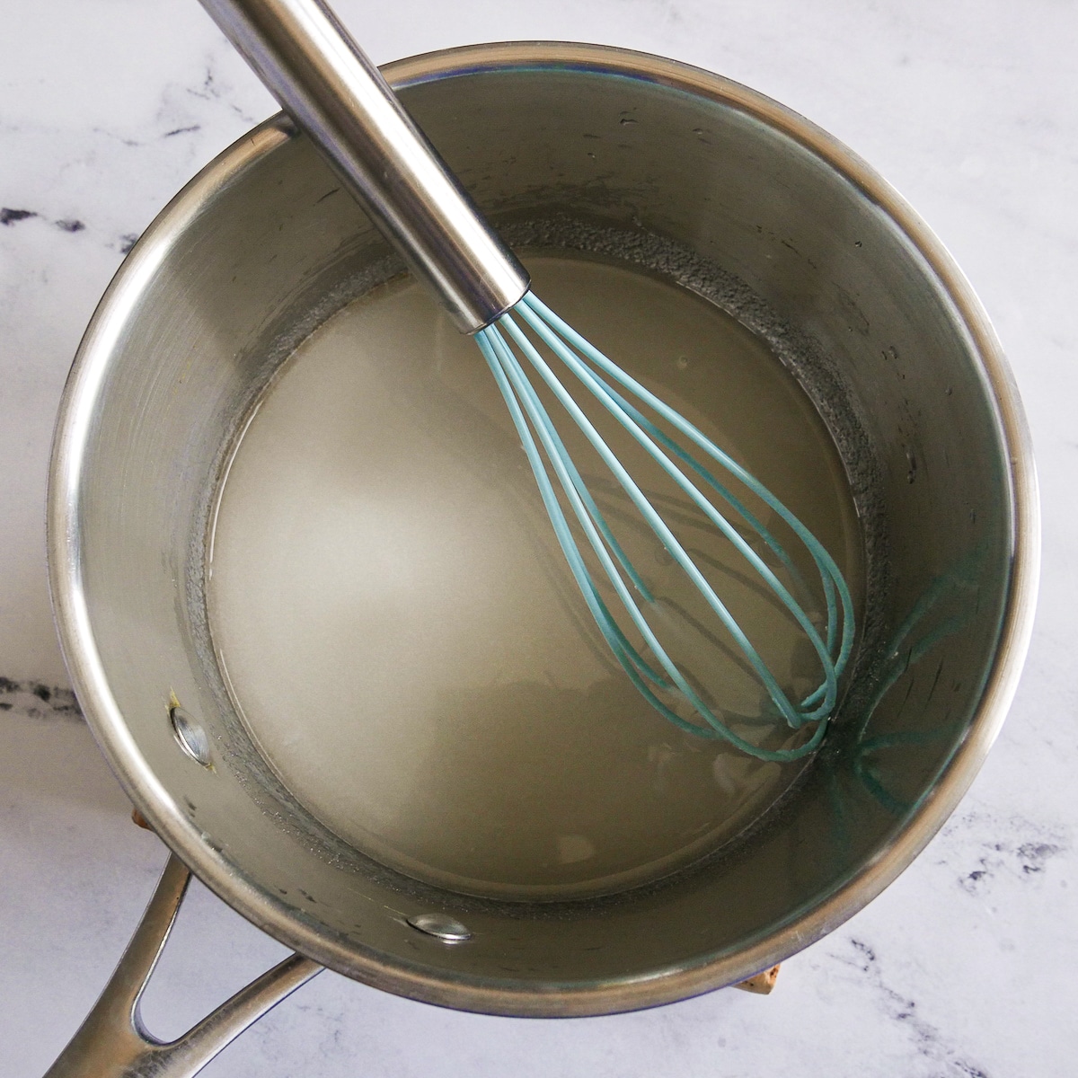 Water and pectin combined in a medium saucepan with a whisk.