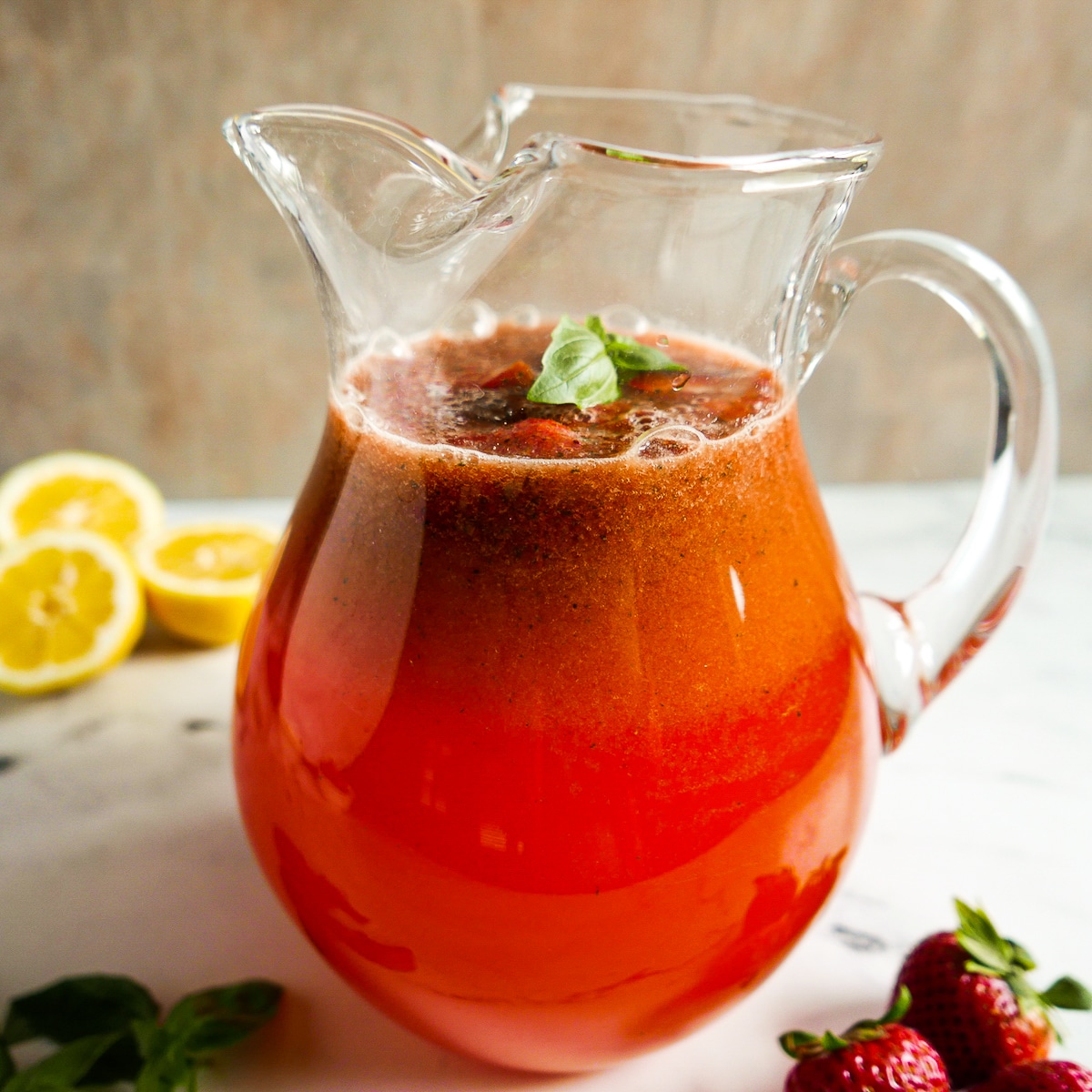 Strawberry lemonade poured into a large pitcher.