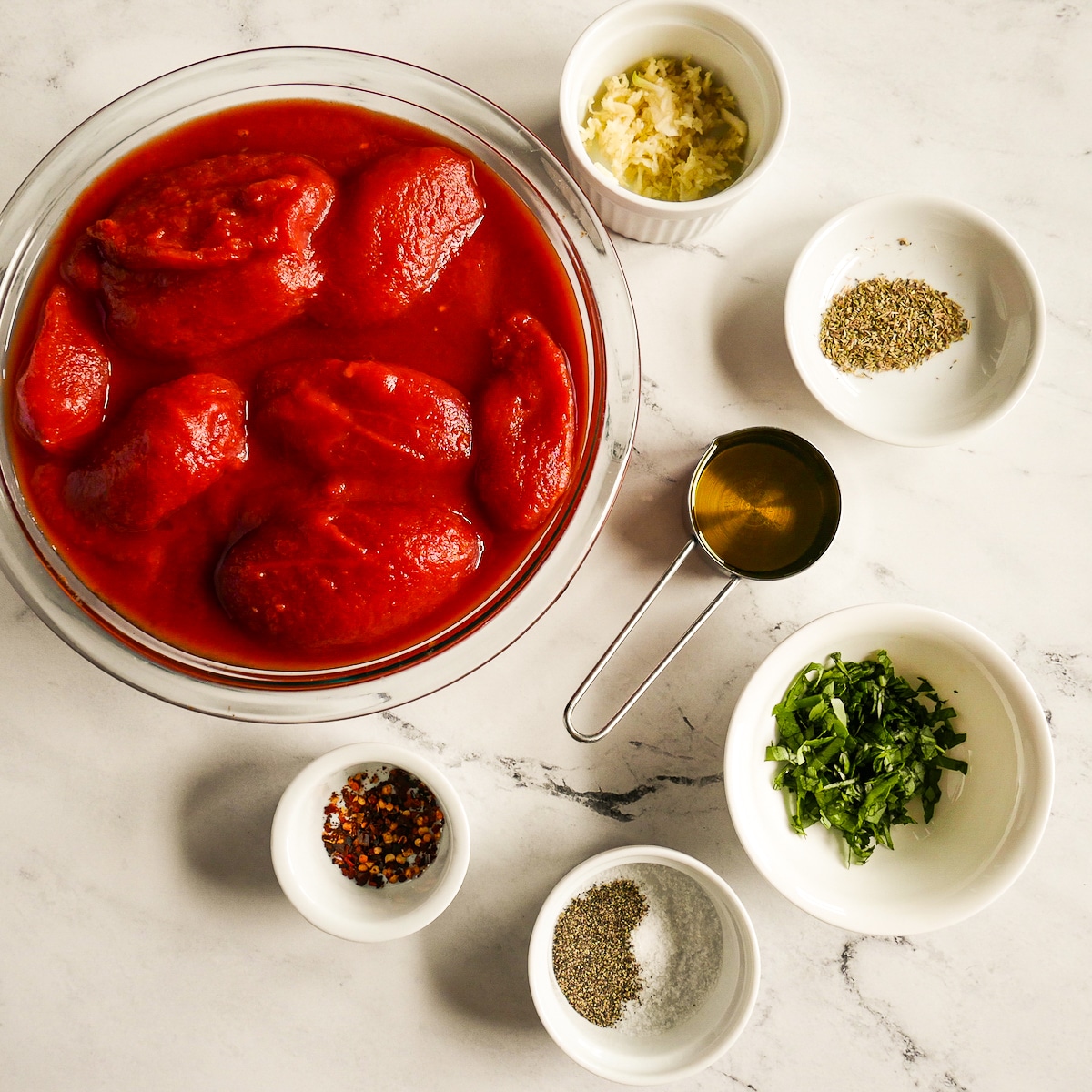 Tomato sauce ingredients placed on a table.