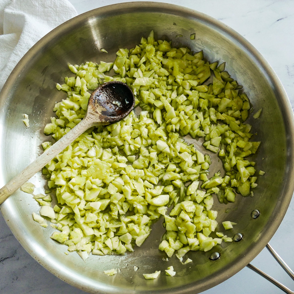 cooking-zucchini-flesh.jpg Zucchini flesh added to a hot skillet with olive oil.