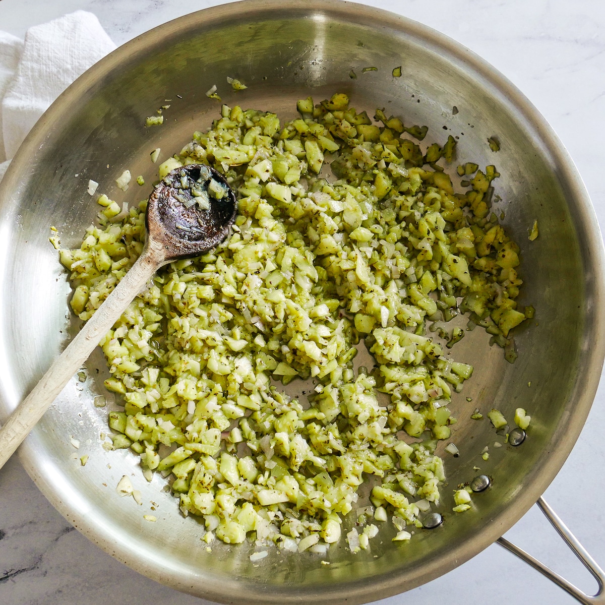 seasoned-zucchini-flesh.jpg Shallots and seasoning added to cooked zucchini flesh.