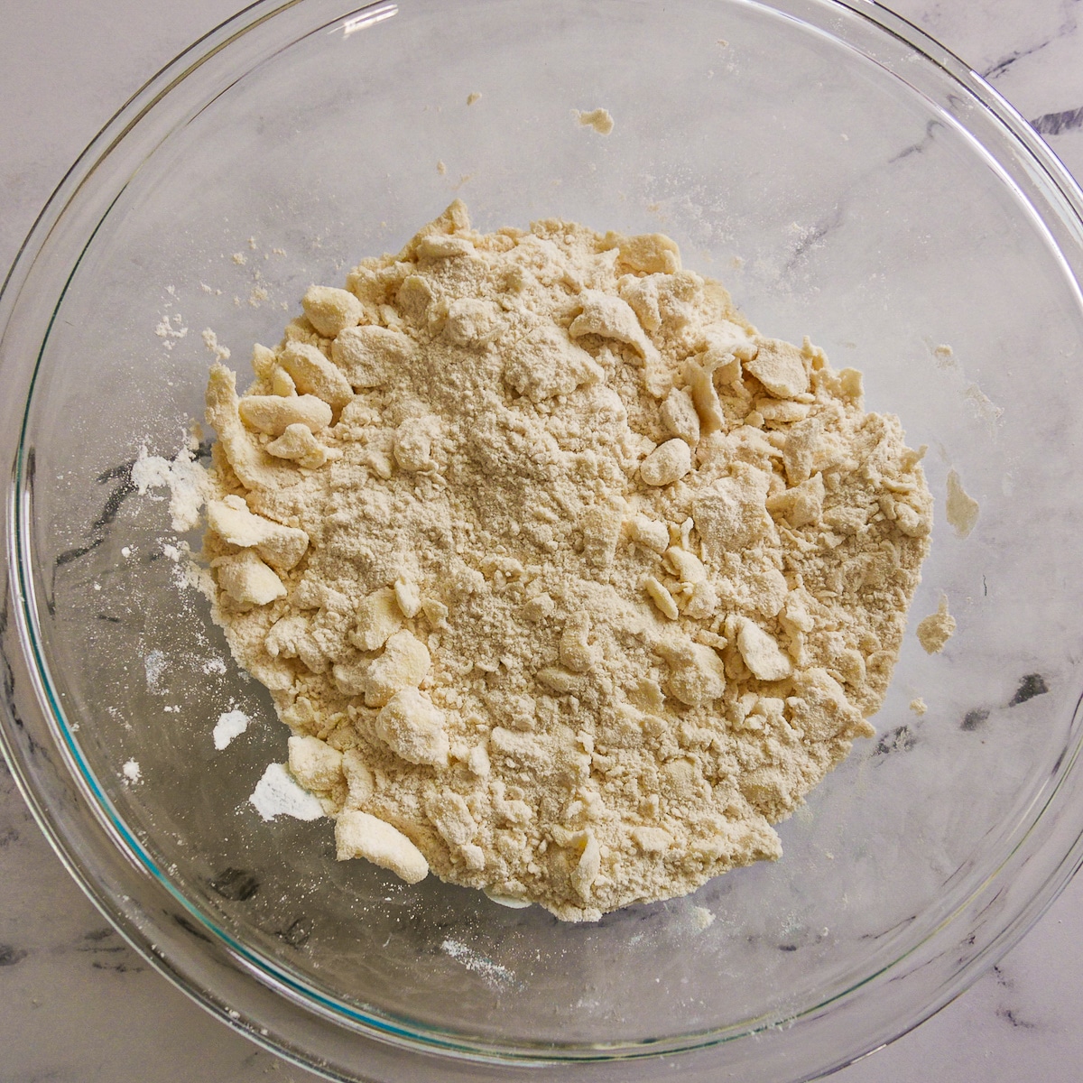butter-in-dry-ingredients.jpg Cold butter worked into dry ingredients in a bowl.