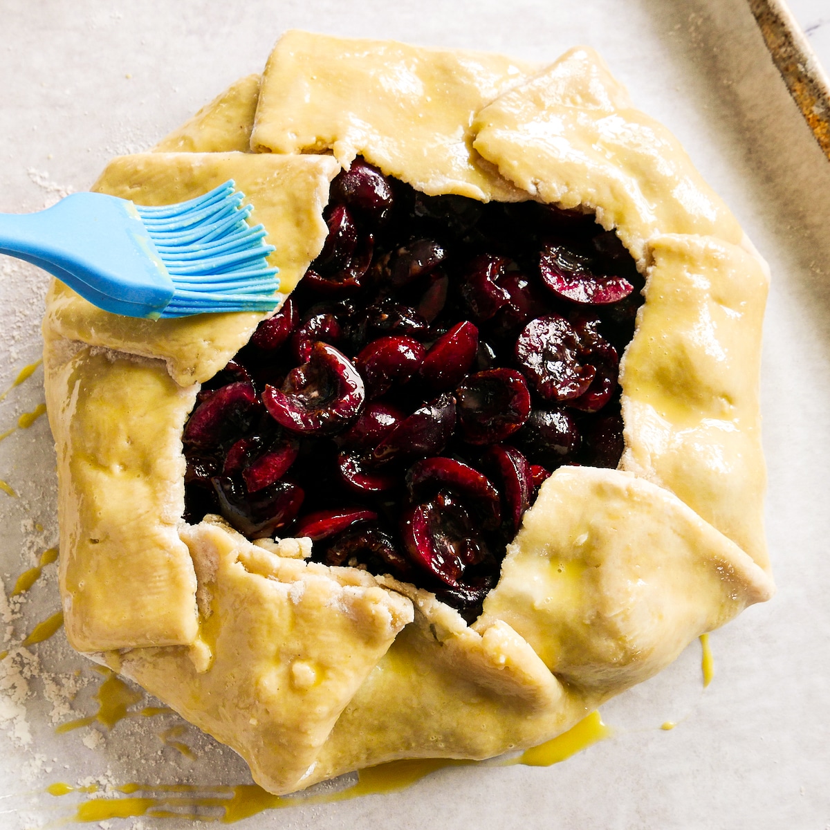 egg-wash-on-galette.jpg Brushing egg wash onto assembled galette.