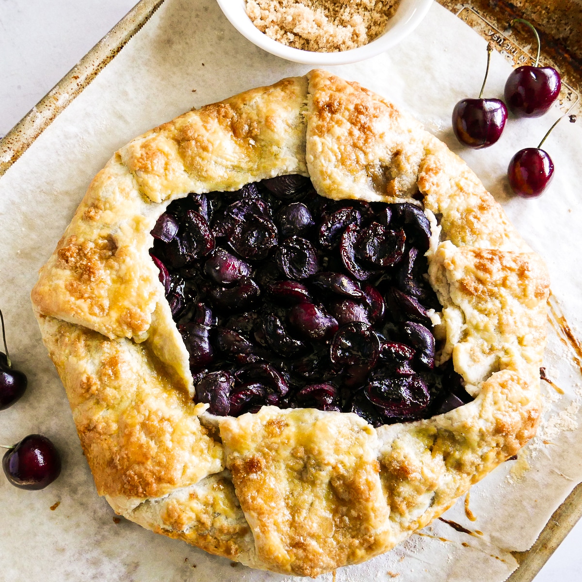 baked-cherry-galette.jpg Baked cherry galette on a parchment-lined baking sheet.