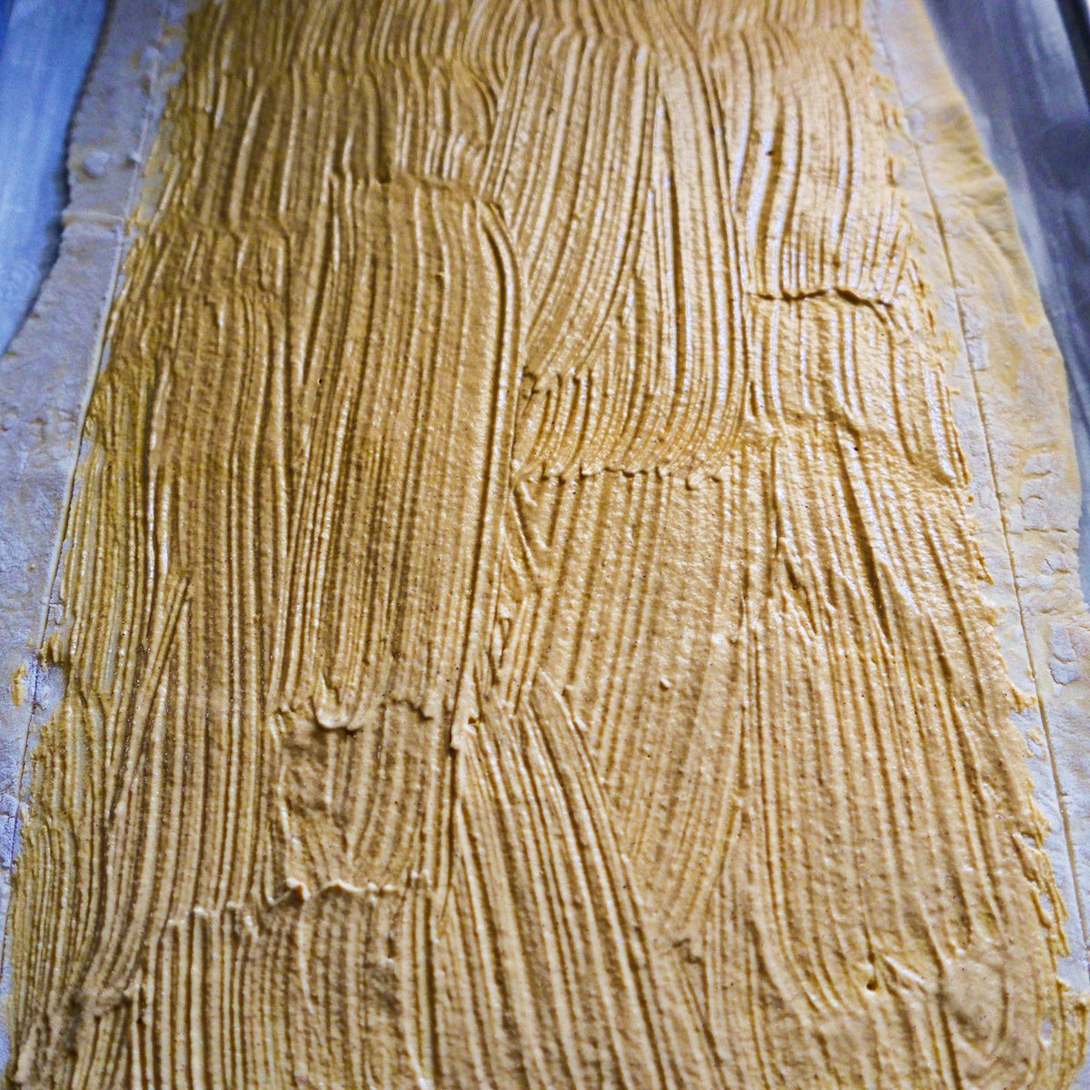 mustard-on-puff-pastry.jpg Mustard brushed on top of puff pastry.