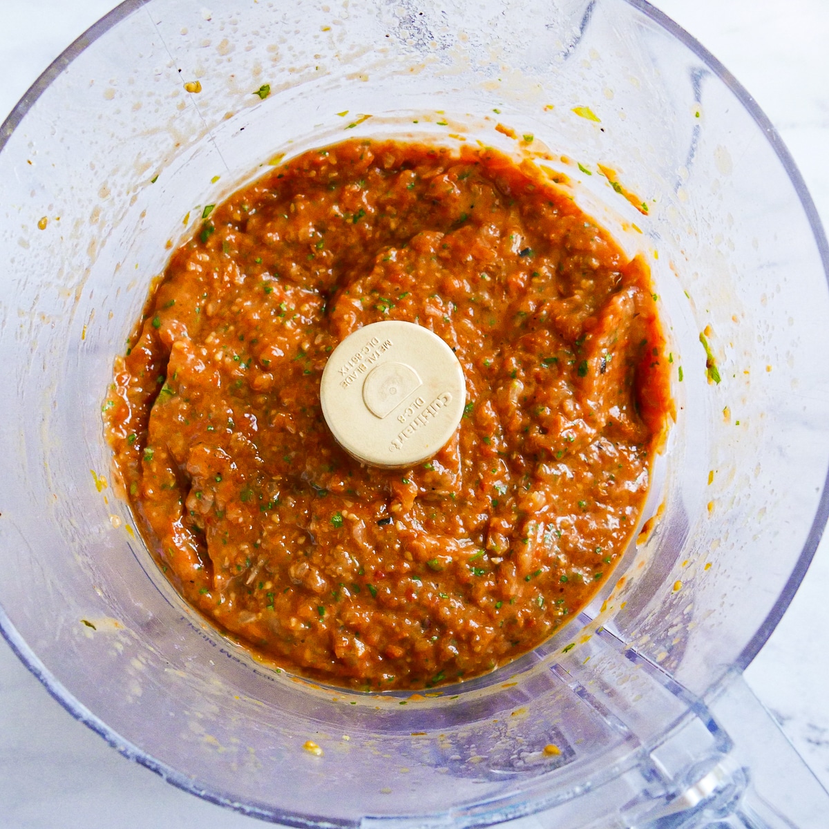 Blended cherry tomato pasta sauce in a food processor.