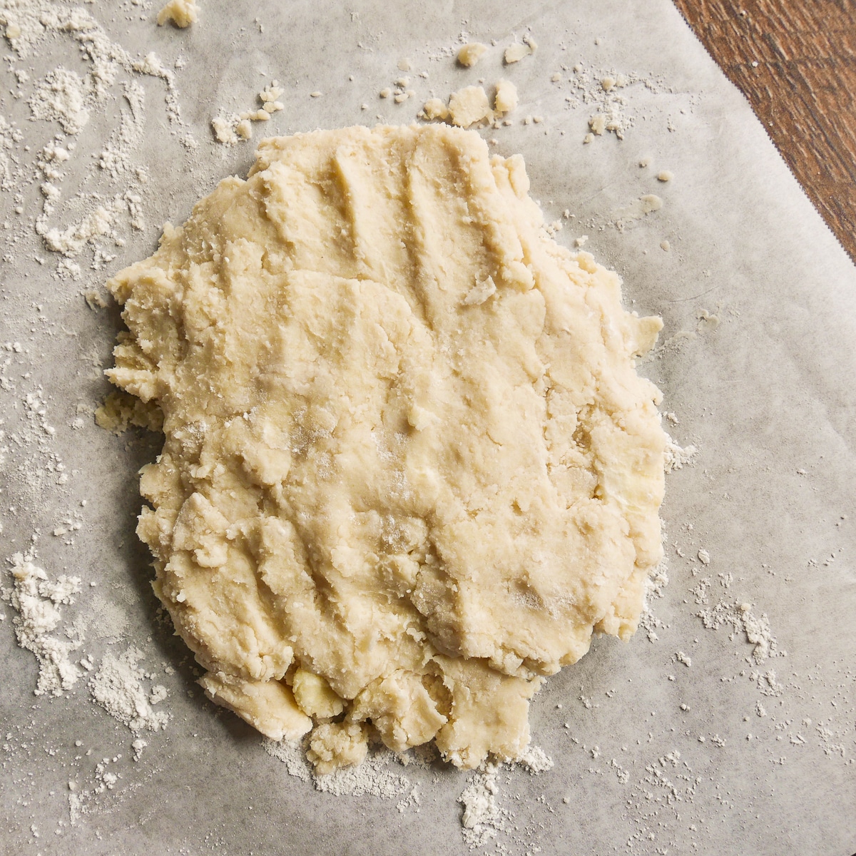 Kneaded galette dough on parchment paper.