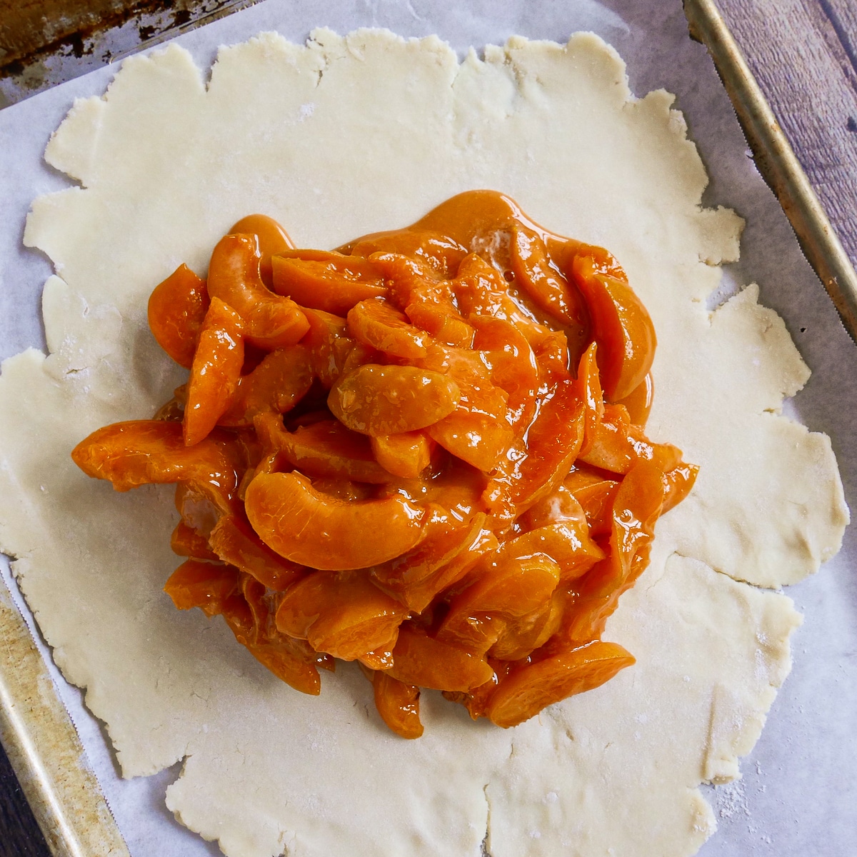 Apricot filling arranged on rolled out dough.