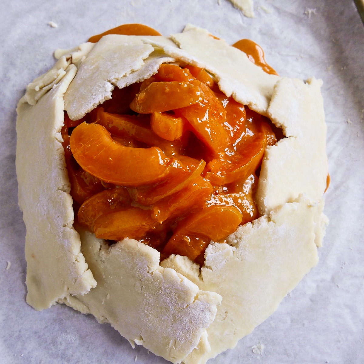 Dough folded up around the apricot filling.