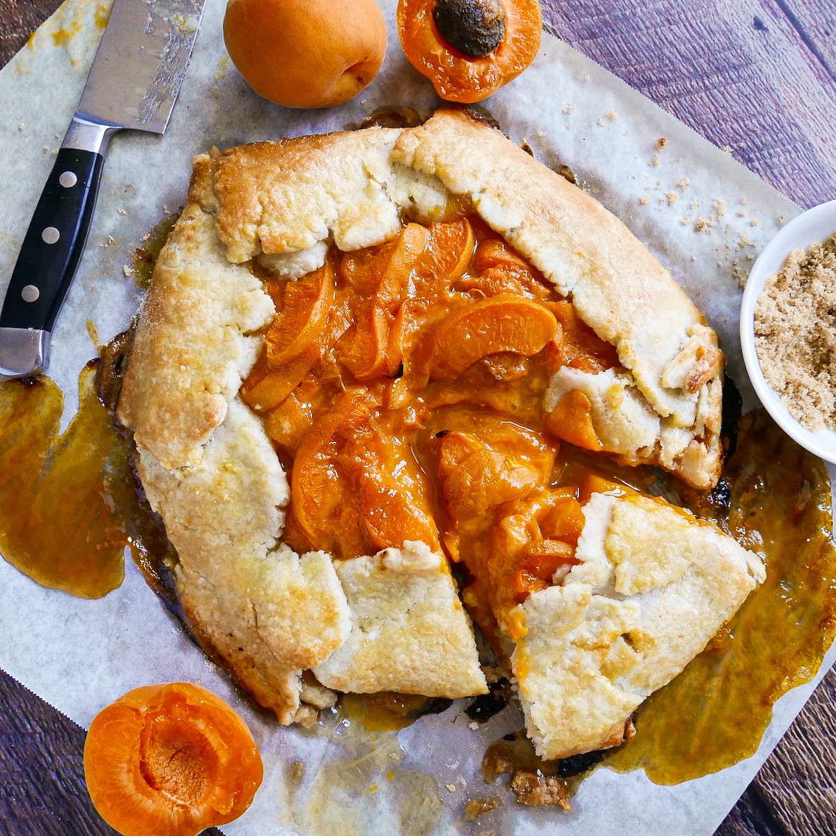 Baked apricot galette resting on a baking sheet.