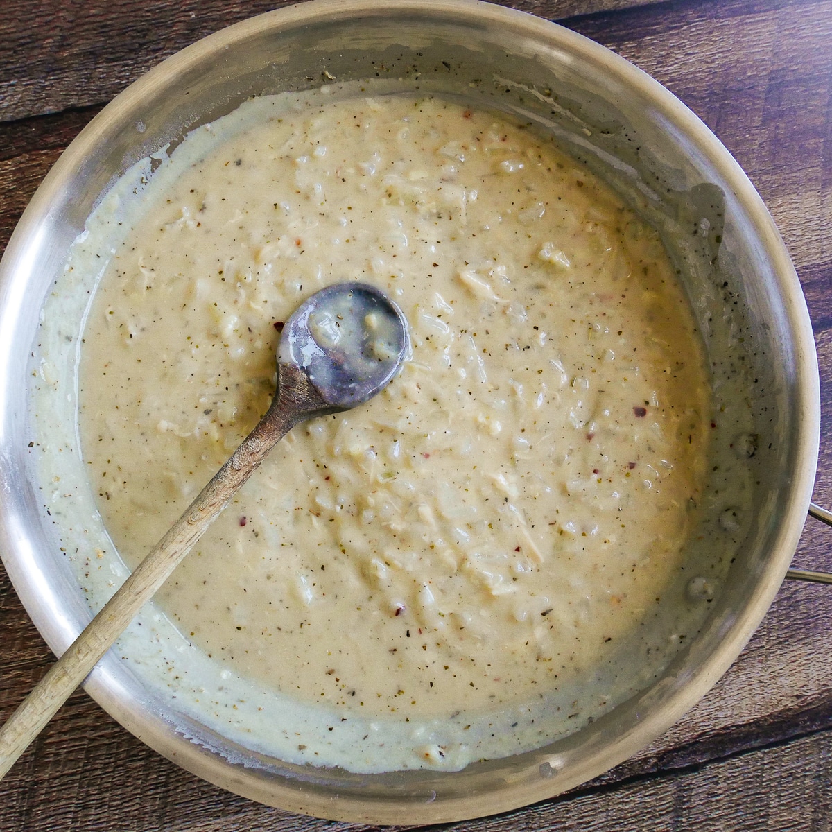 Spices and cheese added to cooking sauce mixture.