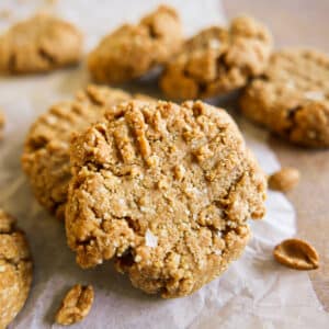 Peanut butter cookies with almond flour on parchment.