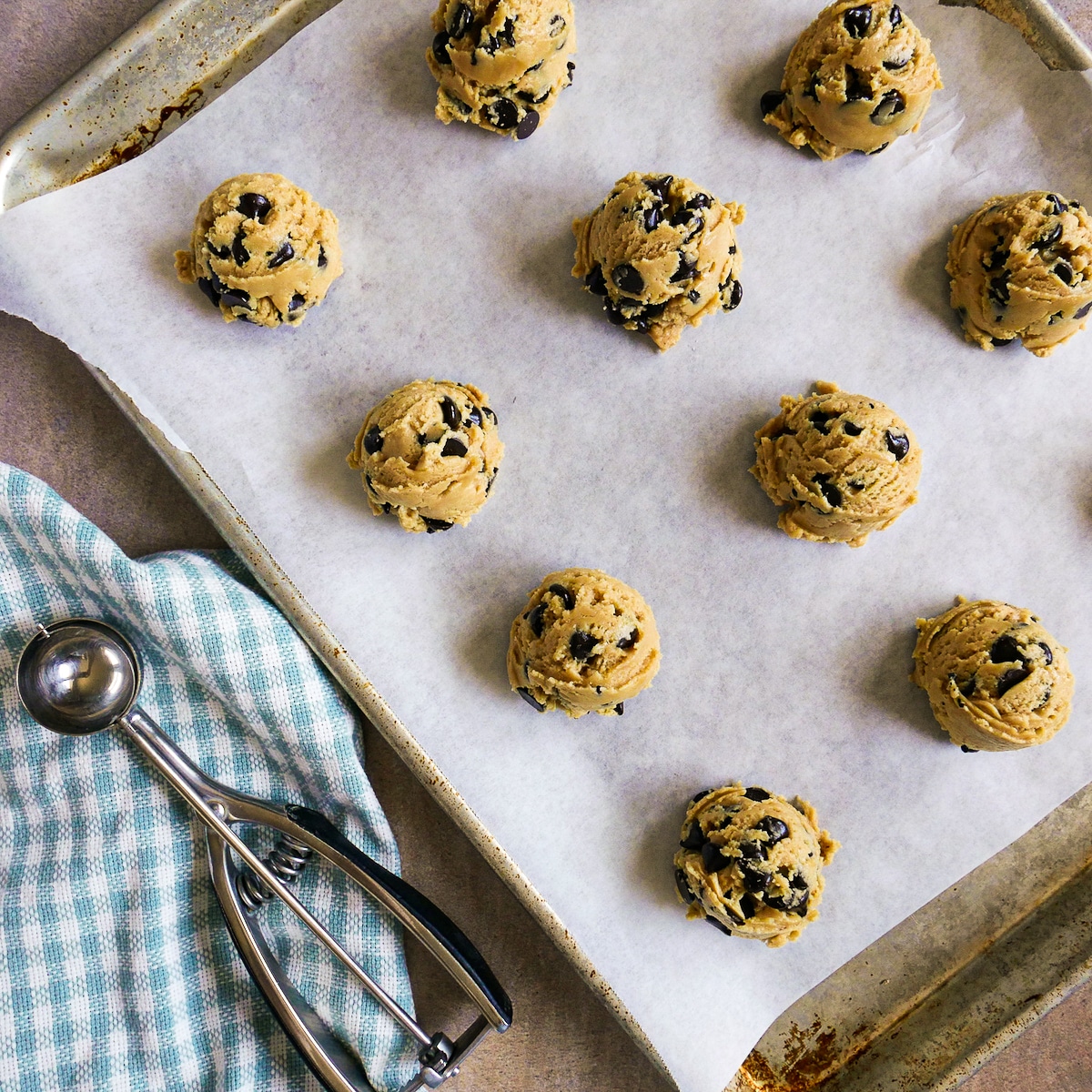 dairy-free-cookie-dough.jpg Dairy free cookie dough portioned onto a baking sheet lined with parchment paper.
